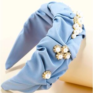 Light blue headband with pearls.